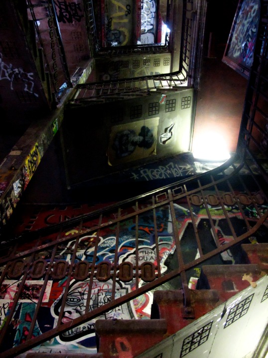 The dark, graffiti-splattered stairwell of Kunsthaus Tacheles, a former art center in Berlin. 